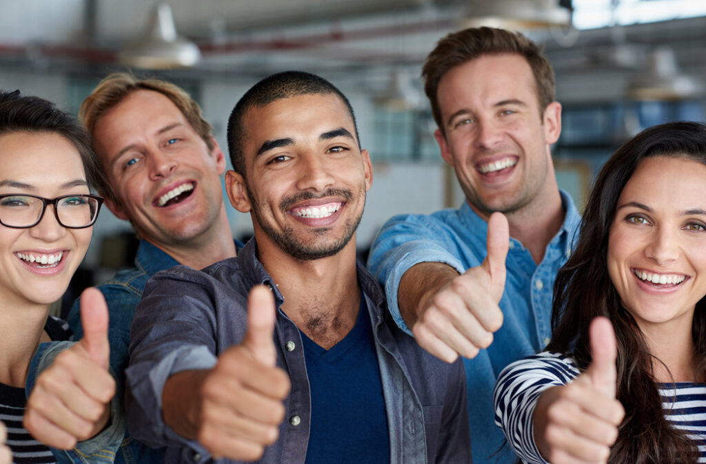 Young group of men and woman giving thumbs up to the Beyond Performance CA.